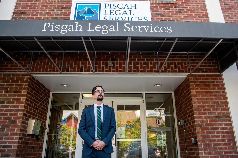 Thomas Lodwick, Public Benefits Program Director at Pisgah Legal Services, stands in front of its office.