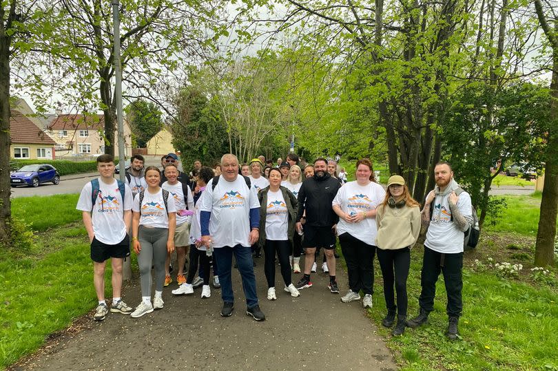 Almost 100 people took part in the walk raising money for Chris's House in memory of Liam -Credit:Lisini Group