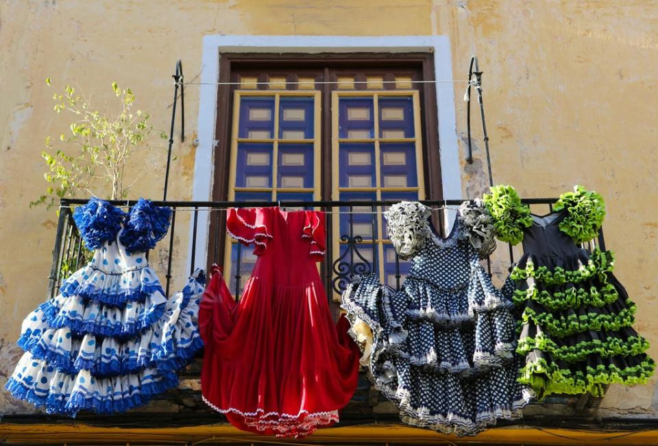 Flamenco dresses hang from a balcony (Getty/iStock)