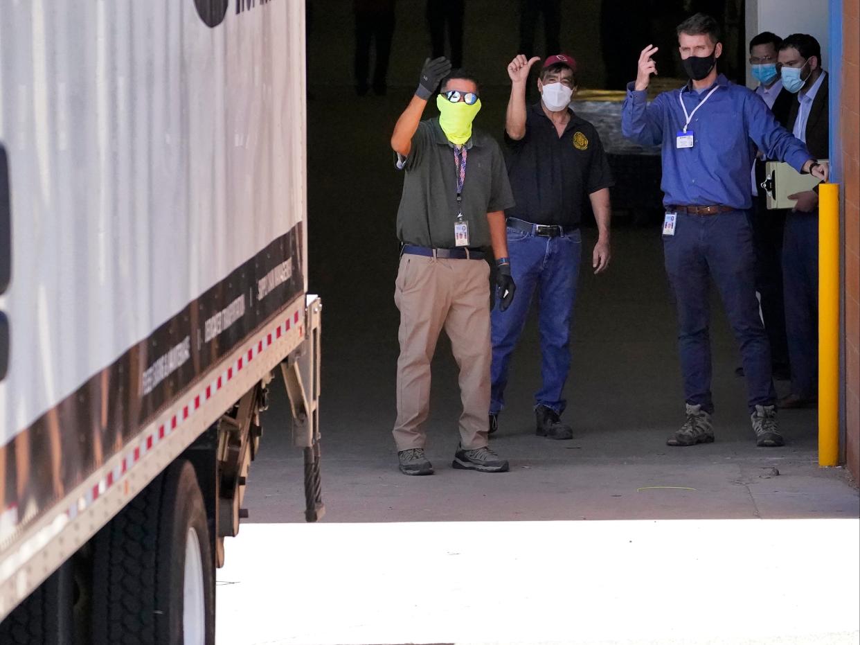 Officials guide a truck into the loading area of the Veterans Memorial Coliseum on Wednesday, April 21, 2021, in Phoenix, Arizona.  (AP)