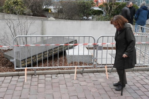 The large black marble slab, that marks the site of the destroyed Old Synagogue, was knocked off its plinth