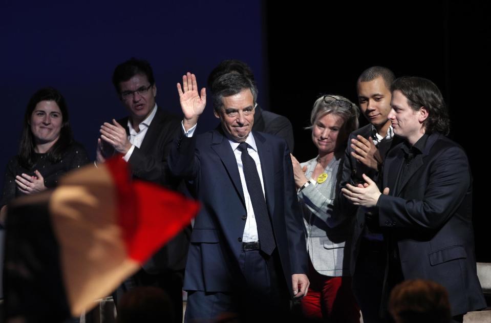 Conservative presidential candidate Francois Fillon waves as he arrives to deliver his speech during a campaign meeting in Aubervilliers, outside Paris, France, Saturday, March 4, 2017. Fillon, whose campaign has been unraveling over impending corruption charges, vowed to remake France in a speech on Saturday, a day before what amounts to his last stand, a rally near the Eiffel Tower widely seen as a test of his staying power via the number of supporters he can muster. (AP Photo/Christophe Ena)