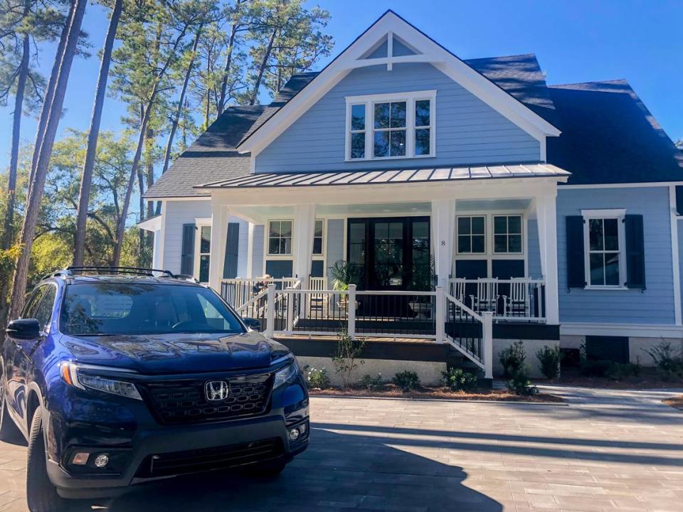 The HGTV 2020 Dream Home in Windmill Harbour on Hilton Head Island, with a Honda Passport Elite parked in its driveway. The winner of the giveaway will win both the car and home.