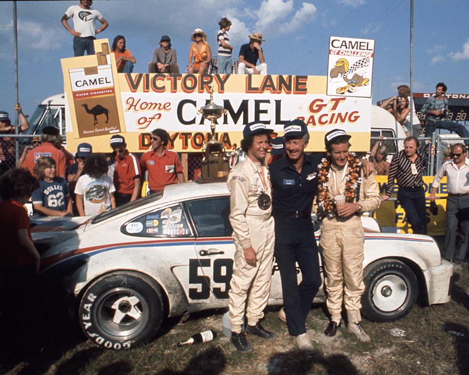 DAYTONA BEACH, FL — February 2, 1975:  Co-drivers Peter Gregg (L) and Hurley Haywood (R) celebrate in victory lane at Daytona International Speedway after driving their Brumos Porsche Carrera RSR 911 to the win in the 24 Hours of Daytona.  The pair finished 15 laps ahead of the second place team.