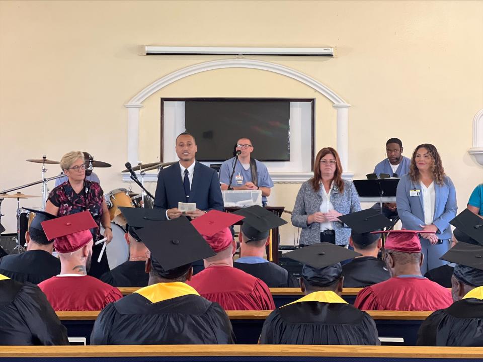 Ray Childs, education supervisor at Polk Correctional Institution, speaks to the graduates before handing them their certificates.