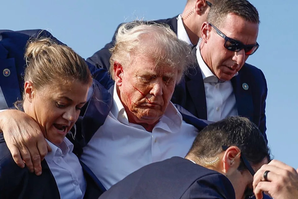 <p>Anna Moneymaker/Getty</p> Donald Trump is escorted away by Secret Service after an assassination attempt on July 13, 2024