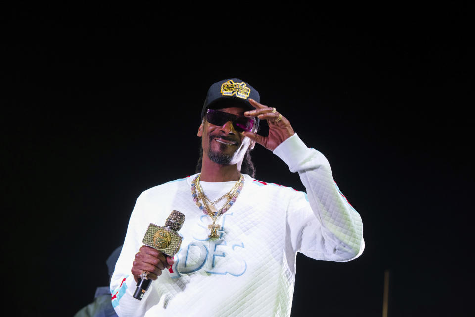 FILE - In this Jan. 5, 2019 file photo, Snoop Dogg performs onstage at State Farm Arena in Atlanta. The University of Kansas has apologized for its risque Late Night at the Phog event in which the rapper performed, stripper poles were wheeled onto the Allen Fieldhouse floor and fake money was shot over the heads of prospective recruits. Athletic director Jeff Long said Friday, Oct. 4 "we expected a clean version of the show." Long said in a statement the school fell short of providing a "family atmosphere" during the annual kickoff for the school's beloved basketball program. (Photo by Paul R. Giunta/Invision/AP, File)