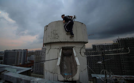 Vad Him of Rudex team climbs up a structure on a rooftop in Moscow, Russia, August 14, 2017. REUTERS/Maxim Shemetov