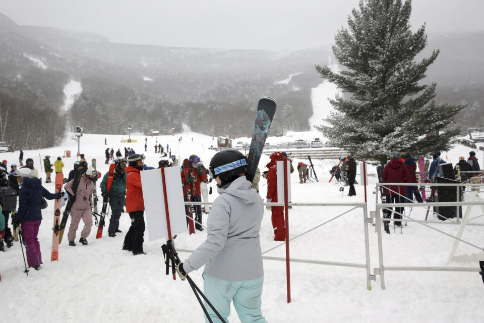 Skiers gather at the Stowe ski resort in Stowe, Vt., Friday, Feb. 4, 2022. While much of the northern United States was digging out from a winter storm, skiers were thrilled with the added snow. (AP Photo/Wilson Ring)