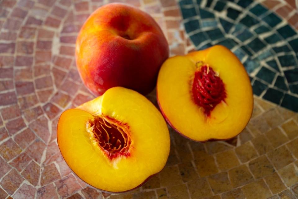 Nectarine cut in half with the fruit pit showing.