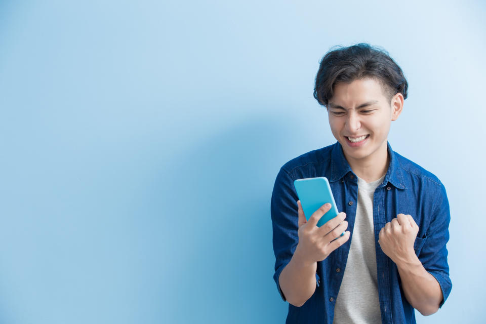 A young man uses a smartphone.