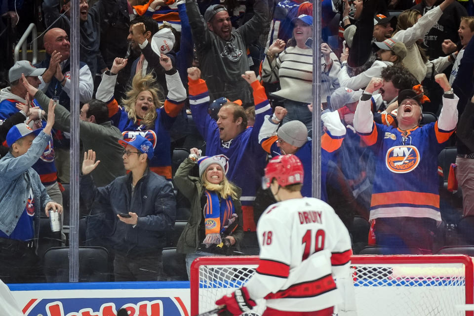 New York Islanders fans celebrate after center Kyle Palmieri scored a goal during the third period of Game 3 in an NHL hockey Stanley Cup first-round playoff series against the Carolina Hurricanes Friday, April 21, 2023, in Elmont, N.Y. (AP Photo/Bryan Woolston)