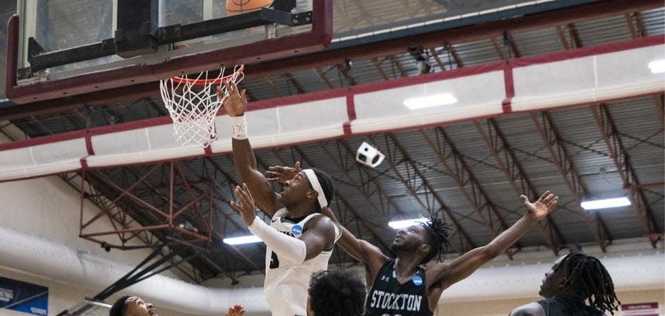 Nichols College guard Jakigh Dottin, left, goes in for a layup during Friday's NCAA Division 3 third round game against Stockton University (NJ) in Swarthmore, Pa.