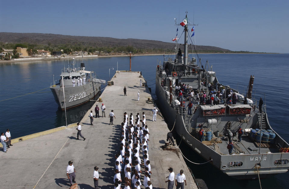 FILE - In this May 12, 2005 file photo, inmates line up on the pier after arriving at the Islas Marias federal prison island, located 90 miles south of Mazatlan, Mexico. President Andres Manuel Lopez Obrador said on Monday, Feb. 18, 2019 that he will close the famed island penal colony and will have it converted into a cultural and environmental education center. (AP Photo/Eduardo Verdugo, File)