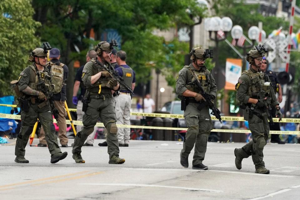 Law enforcement search after a mass shooting at the Highland Park Fourth of July parade in downtown Highland Park, Ill., a suburb of Chicago (AP)