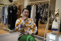 Zhang Na, whose fashion label, Reclothing Bank, sells clothes, bags and other accessories made from materials such as plastic bottles, fishing nets and flour sacks, speaks during an interview at her store in Shanghai on March 19, 2024. (AP Photo/Ng Han Guan)