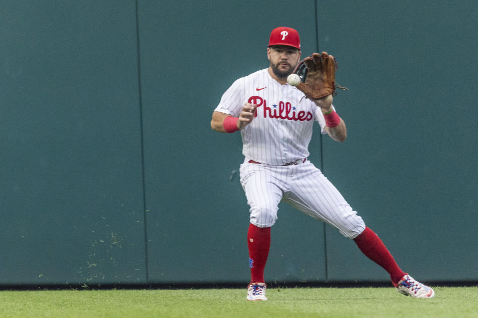 Philadelphia Phillies left fielder Kyle Schwarber fields a single from Washington Nationals' Lane Thomas during the first inning of a baseball game Friday, June 30, 2023, in Philadelphia. (AP Photo/Laurence Kesterson)