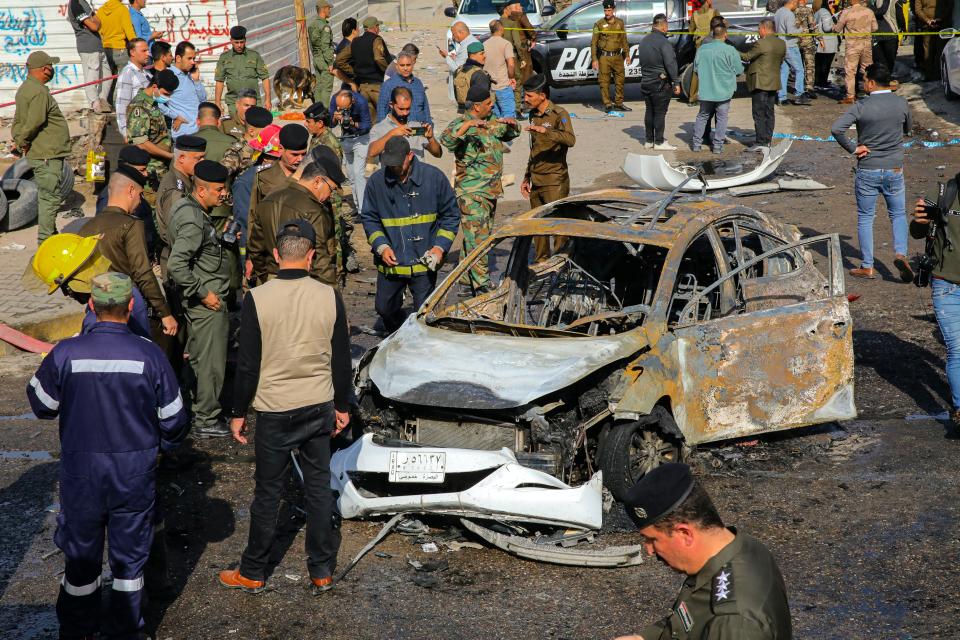 Iraqi security forces inspect the site of an explosion in Basra, Iraq, Tuesday, Dec. 7, 2021. The explosion rocked the center of Iraq’s southern city of Basra, killing at least four people and wounding several others. Local news reports initially reported a car bomb, but the governor of Basra told reporters on the scene that a motorcycle had exploded. (AP Photo/Nabil al-Jurani)