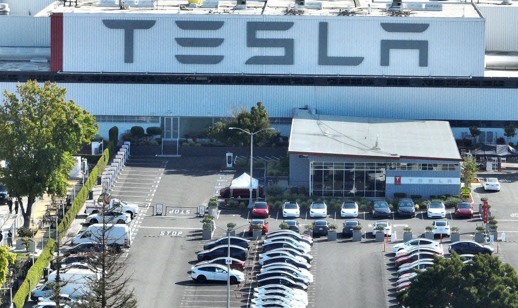 A parking lot outside a Tesla building.