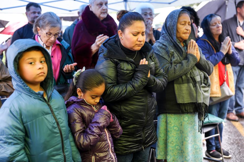 Parishioners pray during Mass outside of St. Joseph’s Catholic Church after a fire significantly damaged the church. The oldest Catholic parish in Salem, it has a diverse congregation and provides services in English, Spanish, Vietnamese and Latin.