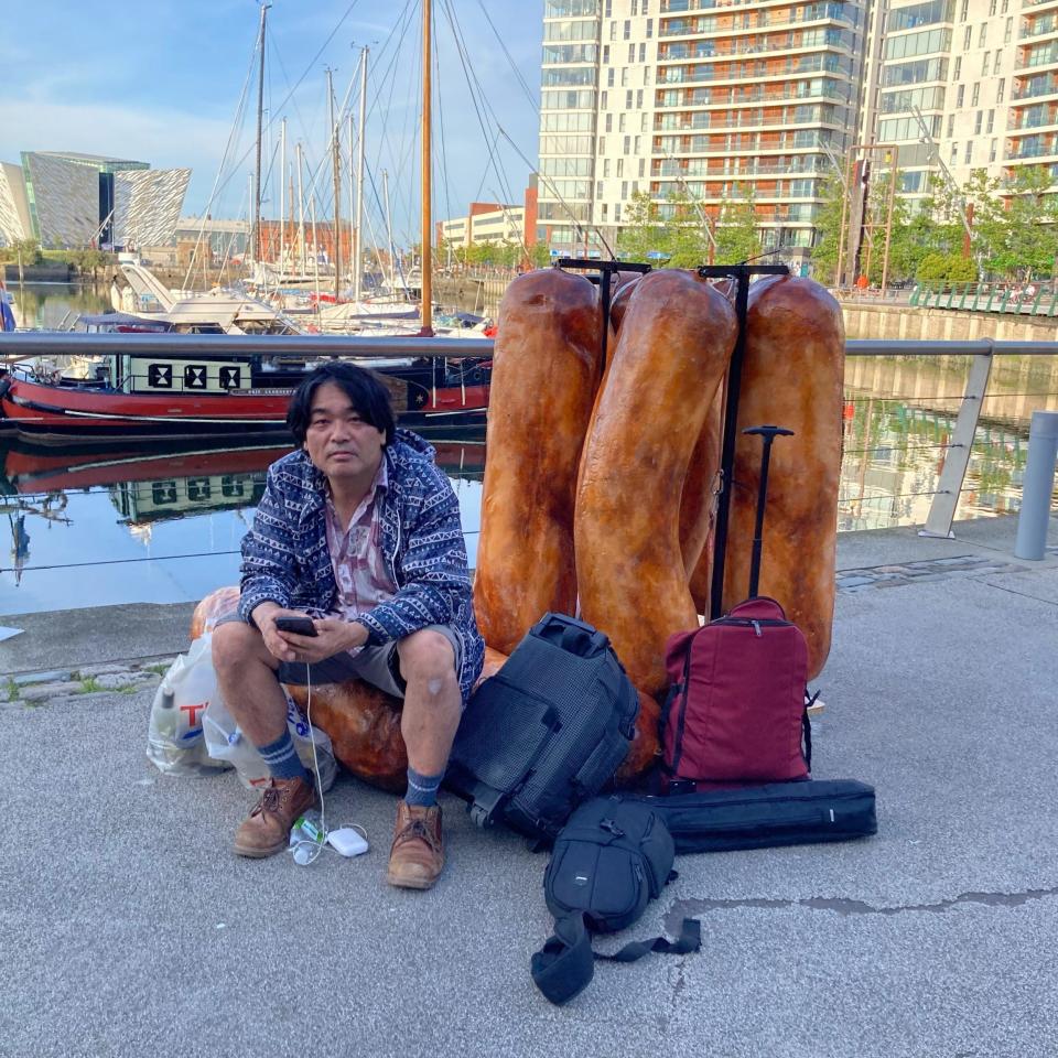 Shiro Masuyama pictured with the sausage sculptures - Art Scan