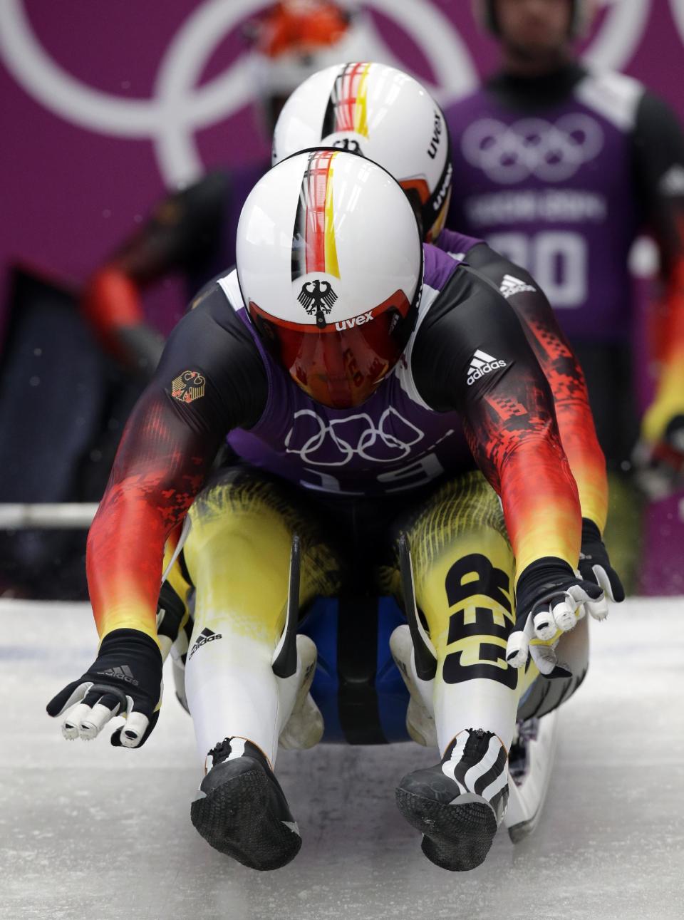 The doubles team of Tobias Wendl and Tobias Arlt from Germany start a run during the men's doubles luge training session at the 2014 Winter Olympics, Monday, Feb. 10, 2014, in Krasnaya Polyana, Russia. (AP Photo/Michael Sohn)