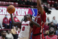 Detroit Mercy guard Antoine Davis attempts a layup as Youngstown State forward Malek Green (2) defends during an NCAA college basketball game, Thursday, Jan. 12, 2023, in Detroit. Davis, the nation's leading scorer, made a personal-best 11 3-pointers in a win over Robert Morris on Jan. 14, giving him 513 in a career few saw coming when he stepped on campus. (AP Photo/Carlos Osorio)