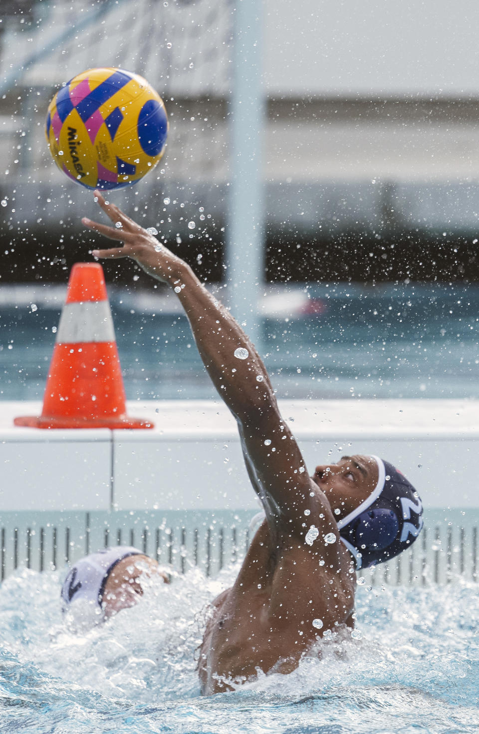 U.S. Olympic Water Polo Team attacker Max Irving, right, trains for the Paris Olympics, at Mt. San Antonio College in Walnut, Calif., on Wednesday, Jan. 17, 2024. Irving's father, Michael Irving, is a Pac-12 college basketball referee. Max Irving is also the only Black man on the U.S. Olympic Water Polo Team and a prominent advocate for diversity in the sport. (AP Photo/Damian Dovarganes)