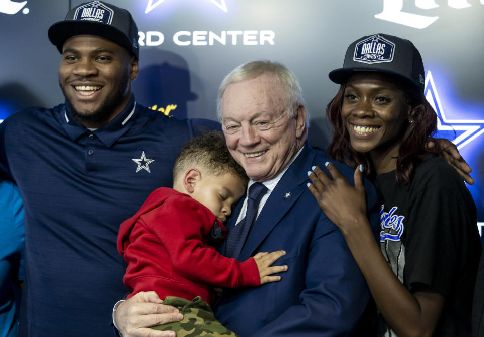 Frpm left to right, Dallas Cowboys first round draft pick linebacker Micah Parsons, his son Malcom, 2, Cowboys owner Jerry Jones and Shatra Parsons pose for photos after a news conference at Cowboys headquarters, Friday, April 30, 2021, in Frisco, Texas. (AP Photo/Brandon Wade)