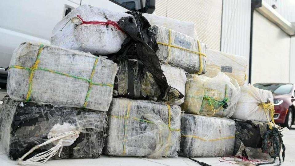 PHOTO: Bales of illicit narcotics are stacked during an offload from Coast Guard Cutter Margaret Norvell at Coast Guard Base Miami, Jan. 9, 2024. The more than 2,450 pounds of drugs are worth an assessed street value of approximately $32.2 million.  (U.S. Coast Guard photo by Petty Officer 2nd Class Diana Sherbs)