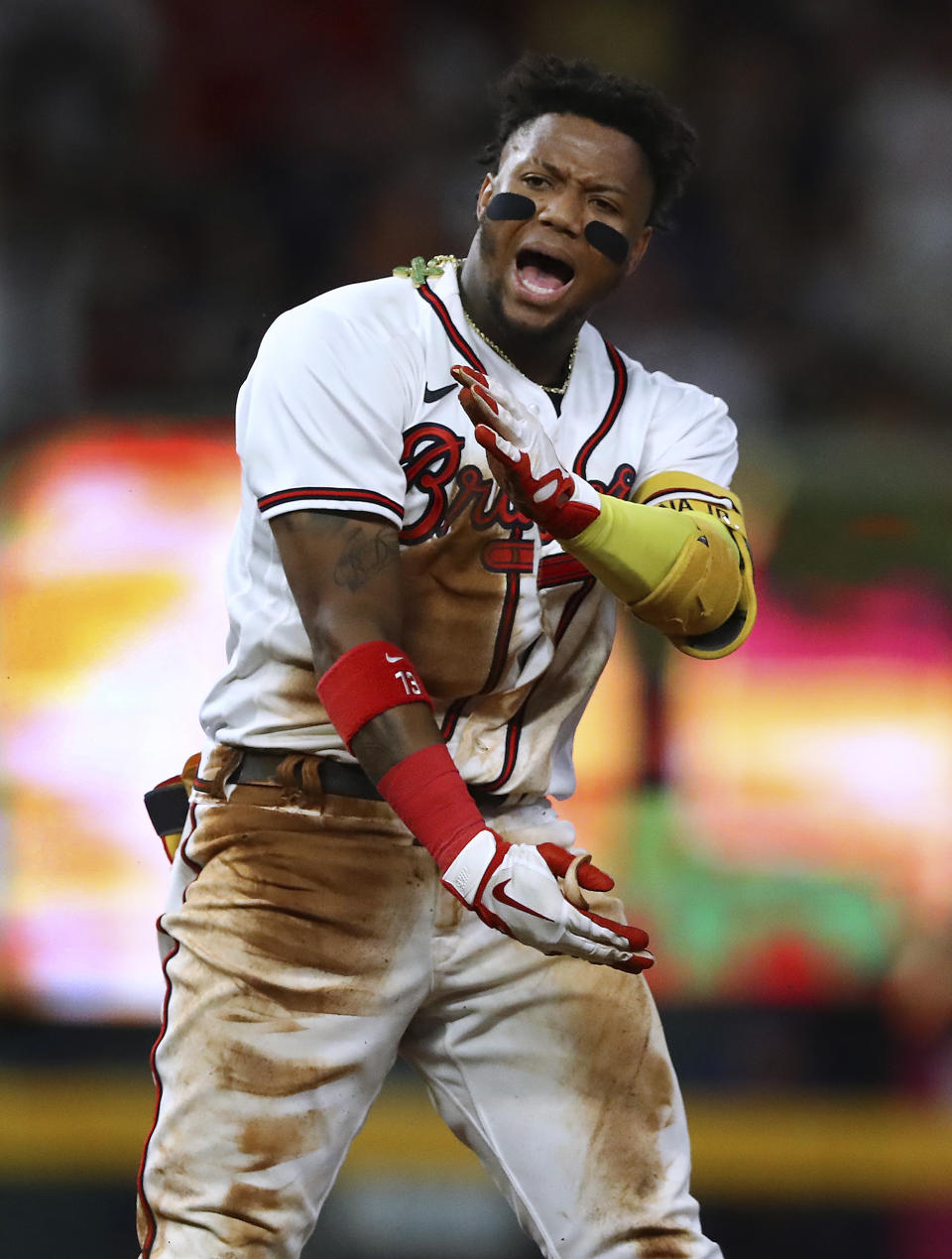 Atlanta Braves outfielder Ronald Acuna yells after sliding into second base for an RBI double against the New York Mets during the fourth inning of a baseball game Monday, Aug, 15, 2022, in Atlanta. (Curtis Compton//Atlanta Journal-Constitution via AP)