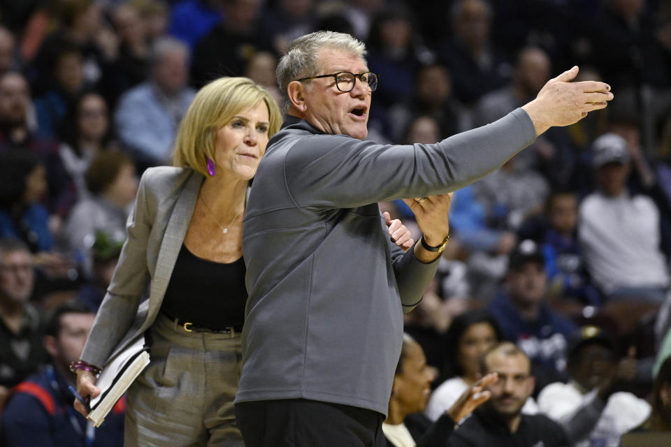 UConn head coach Geno Auriemma, right, gestures while pulled back by associate head coach Chris Dailey during the first half of an NCAA college basketball game against Marquette in the semifinals of the Big East Conference tournament at Mohegan Sun Arena, Sunday, March 5, 2023, in Uncasville, Conn. (AP Photo/Jessica Hill)