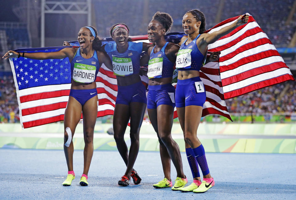 Members of the U.S. women's 4 x 100-meter relay English Gardner, Tori Bowie, Tianna Bartoletta and Allyson Felix, celebrate their gold medal at the Rio Olympics in 2016.  (Jae C. Hong / AP file)