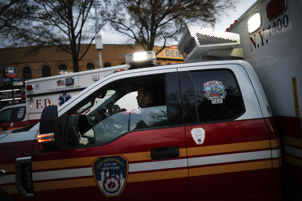 In this April 23, 2020, photo FDNY paramedic Alex Tull, who has recently recovered from COVID-19, prepares to begin his shift outside EMS station 26, the "Tinhouse", in the Bronx borough of New York. (AP Photo/John Minchillo)