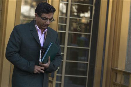 Conservative commentator and best-selling author, Dinesh D'Souza exits the Manhattan Federal Courthouse in New York, January 24, 2014. REUTERS/Brendan McDermid