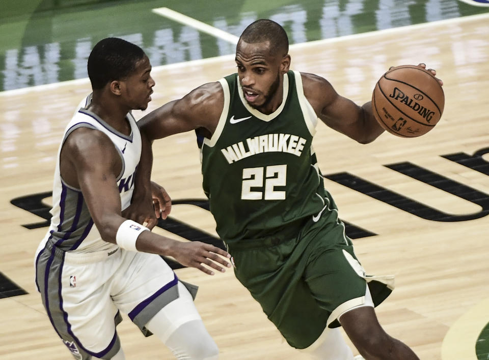 Feb 21, 2021; Milwaukee, Wisconsin, USA; Milwaukee Bucks forward Khris Middleton (22) drives for the basket against Sacramento Kings guard De'Aaron Fox (5) in the third quarter at Fiserv Forum. 