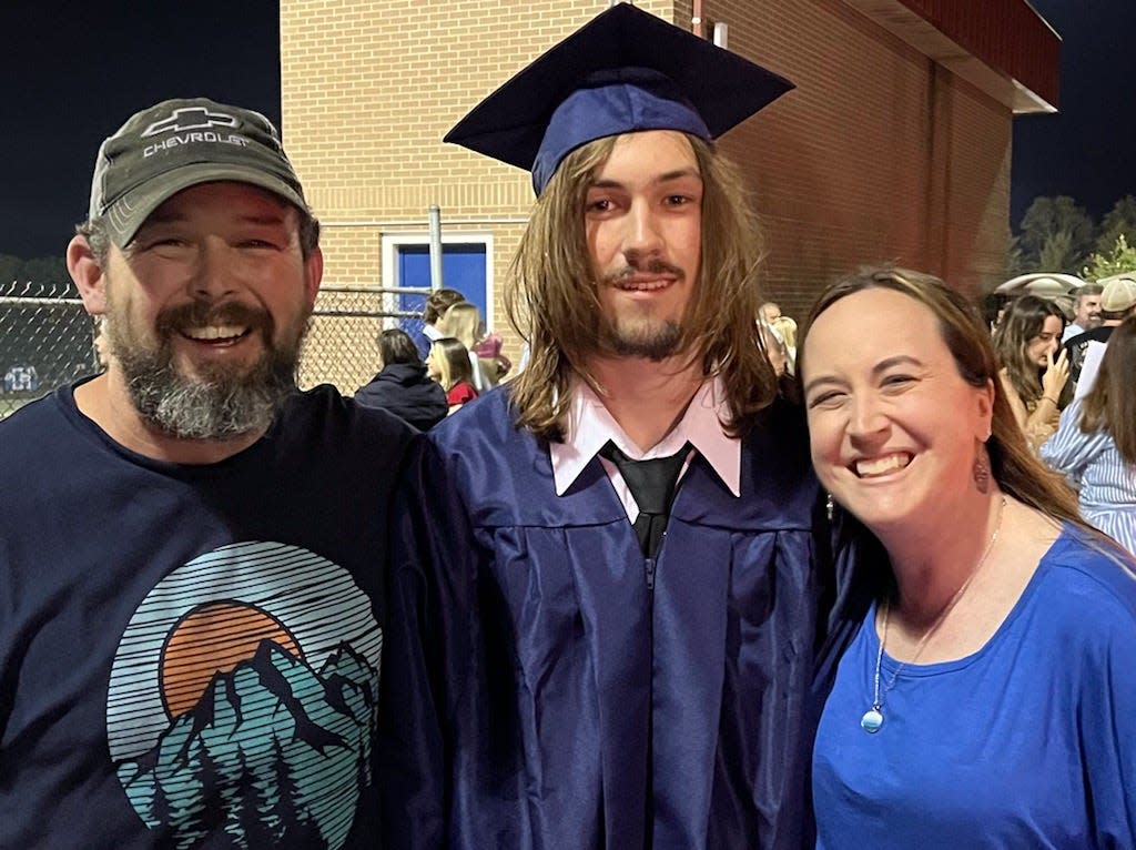 West Henderson 2022 graduate Bryson Parcell poses with his father, Erik, and mother, Kosha.