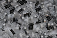 Empty vials of Pfizer's COVID-19 vaccine are pictured at a vaccination site in Paris, Saturday, March 6, 2021. The government plans to inoculate 10 million citizens by mid-April, 20 million by mid-May and a total of 30 million, or two-thirds of the adults by summer. (AP Photo/Christophe Ena)