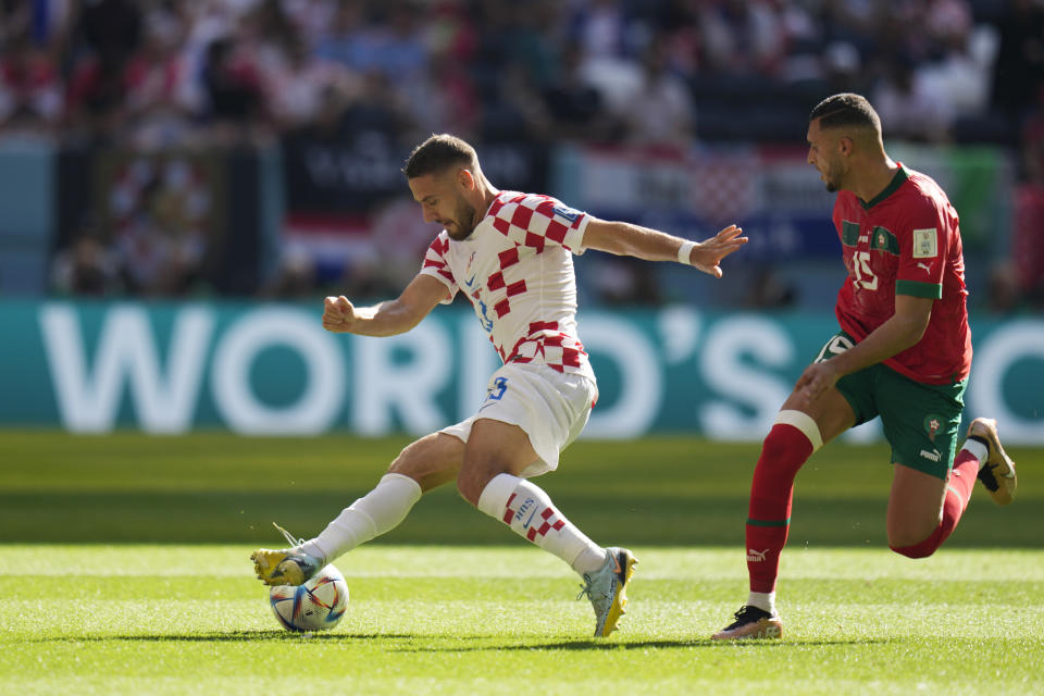 Croatia's Nikola Vlasic, left, and Morocco's Youssef En-Nesyri challenge for the ball during the World Cup group F soccer match between Morocco and Croatia at the Al Bayt Stadium in Al Khor, Qatar, Wednesday, Nov. 23, 2022. (AP Photo/Aijaz Rahi)