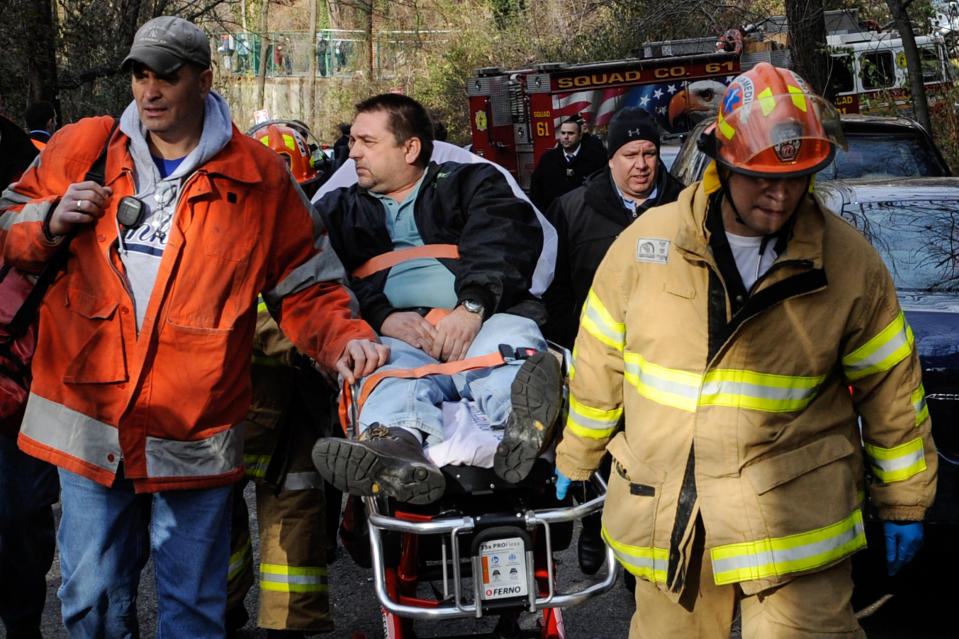 FILE - In this Dec. 1, 2013 photo, Metro-North Railroad engineer William Rockefeller is wheeled on a stretcher away from the area where the commuter train he was operating derailed in the Bronx borough of New York. According to a Federal Railroad Administration review prompted by the derailment that killed four passengers and injured about 70 others, the Metro-North commuter railroad has allowed its emphasis on trains' on-time performance to "routinely" overshadow its safety operations. (AP Photo/Robert Stolarik, File)