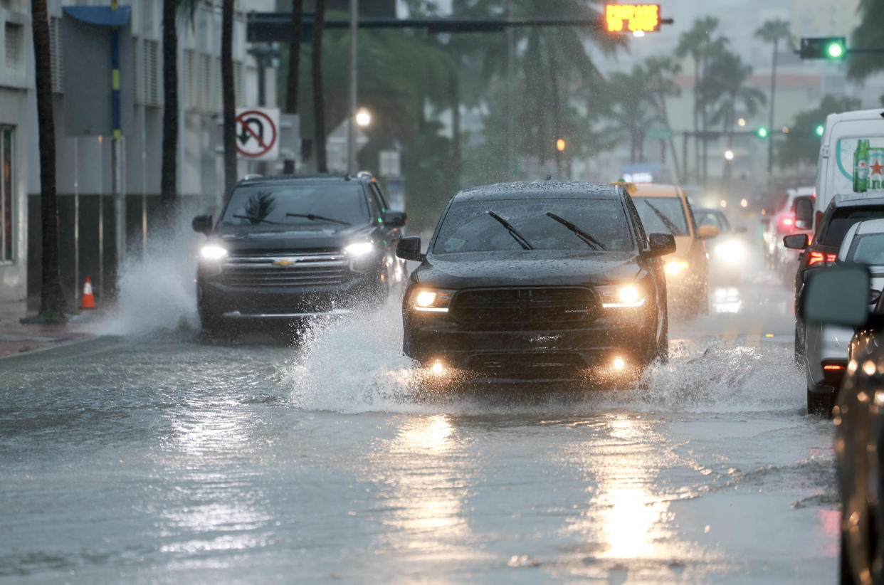 MIAMI BEACH, FLORIDA - JUNE 12: Vehicles make their way through a flooded street on June 12, 2024 in Miami Beach, Florida. Flood concerns are rising in Florida as tropical moisture passes through the area. (Photo by Joe Raedle/Getty Images)