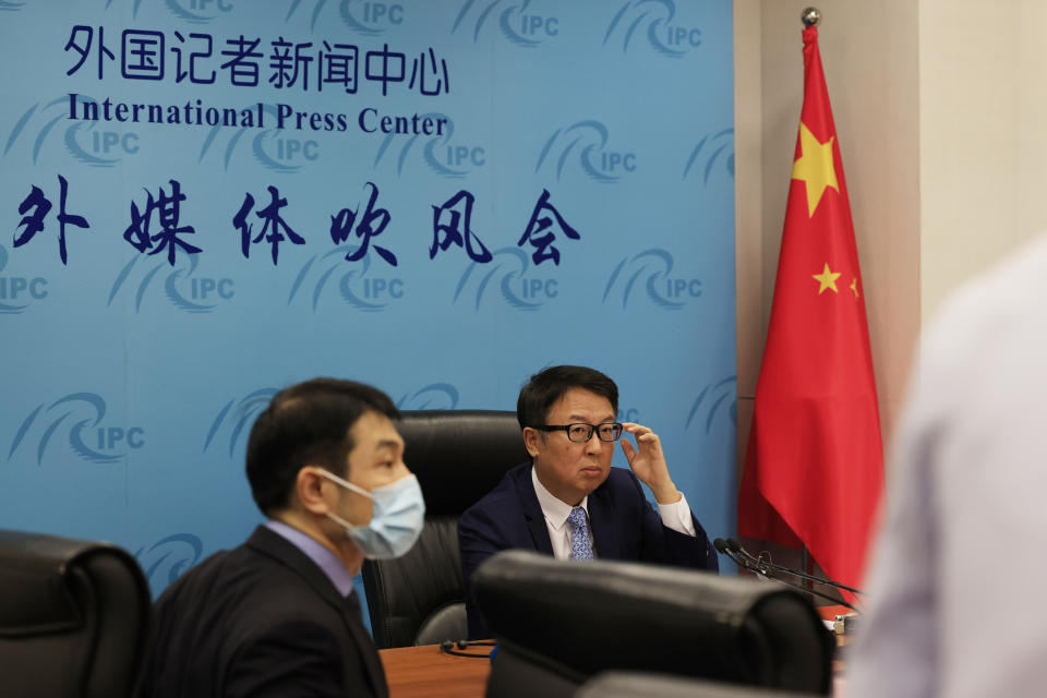 Director of the Chinese Foreign Ministry's Africa Department, Wu Peng, center right, prepares for a briefing in Beijing on Thursday, May 20, 2021. Wu told reporters on Thursday that China is currently providing COVID-19 vaccines to nearly 40 African countries and that the vaccines were either being donated or sold at "favorable prices." (AP Photo/Ng Han Guan)