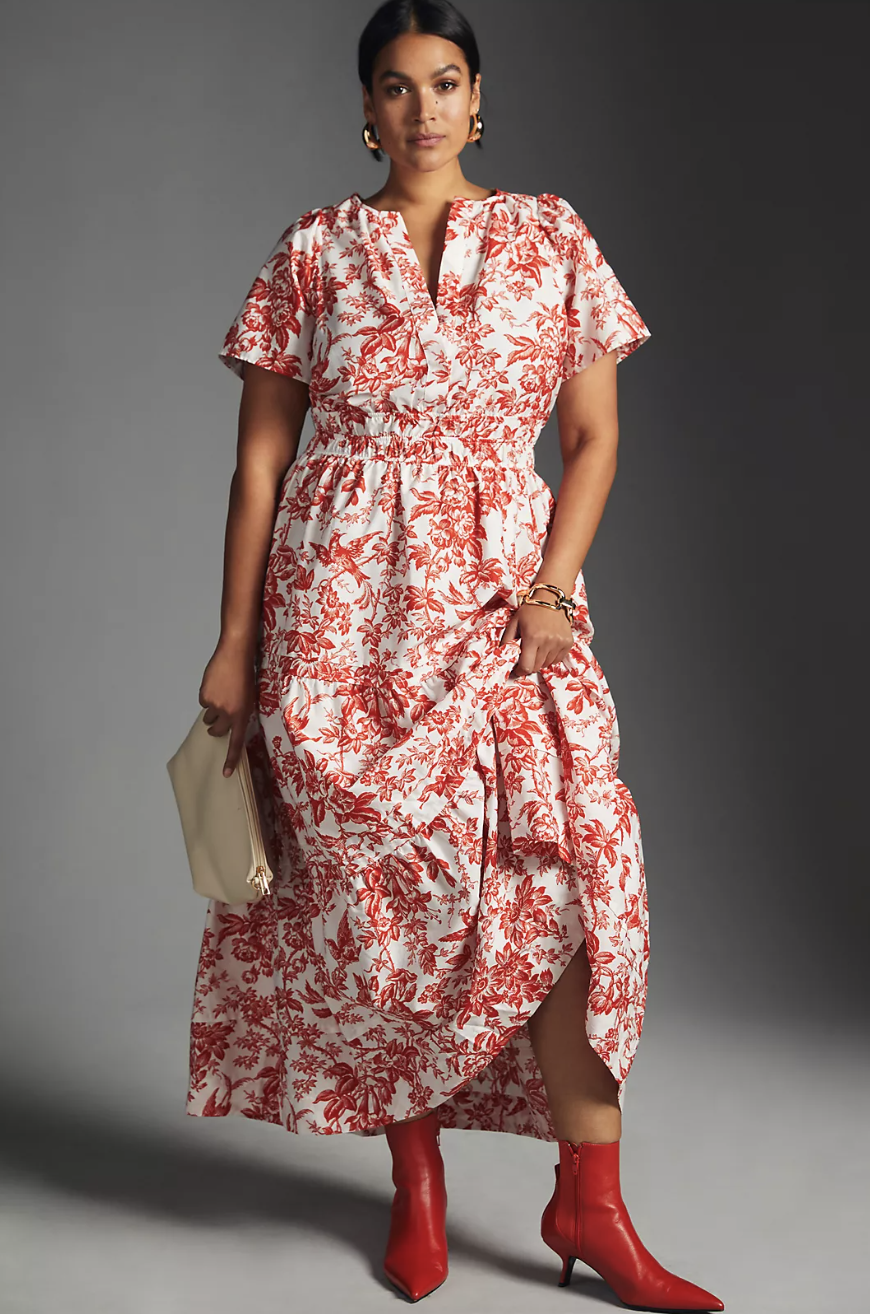 plus size model wearing red heel booties and red and white floral The Somerset Maxi Dress in coral (photo via Anthropologie)