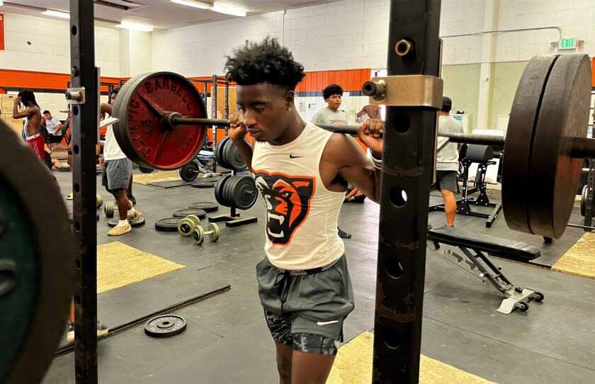 Orange High running back Kobe Boykin get set to squat weights during a workout on Aug. 1.