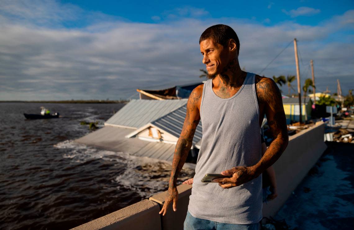 Jason Diamond, 41, surveys damage on Pine Island Road on Thursday, Sept. 29, 2022, in Matlacha, Fla. Hurricane Ian made landfall on the coast of Southwest Florida as a Category 4 storm Tuesday afternoon leaving areas affected with flooded streets, downed trees and scattered debris.