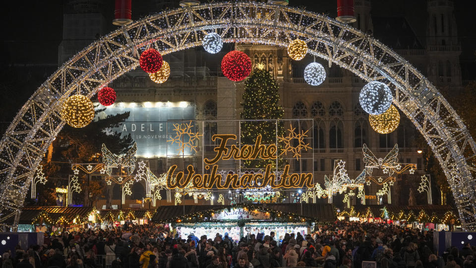 People crowd a Christmas market in Vienna, Austria, Sunday, Nov. 21, 2021. The Austrian government announced a nationwide lockdown that will start Monday and comes as average daily deaths have tripled in recent weeks and hospitals in heavily hit states have warned that intensive care units are reaching capacity.(AP Photo/Vadim Ghirda)