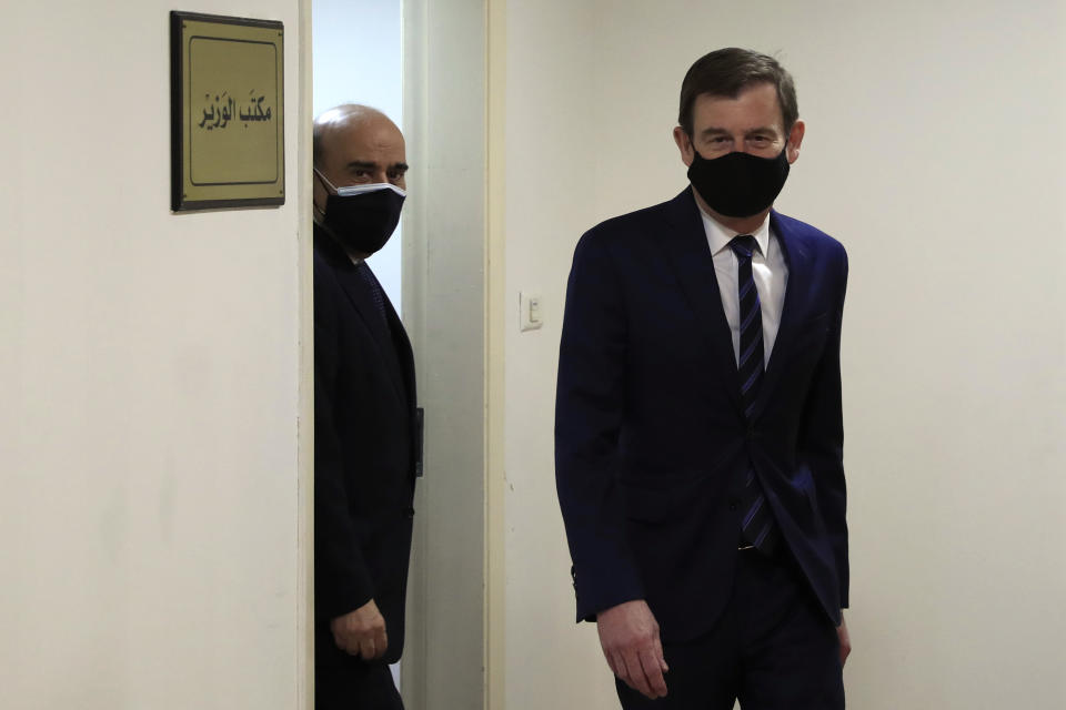 U.S. Undersecretary of State for Political Affairs David Hale, right, leaves the office of the Lebanese Foreign Minister Charbel Wehbe, left, in Beirut, Lebanon, Wednesday, April 14, 2021. Hale berated Lebanese officials for fighting over the shape of a new government for months while millions of Lebanese endure mounting economic and social hardship. (AP Photo/Hussein Malla)