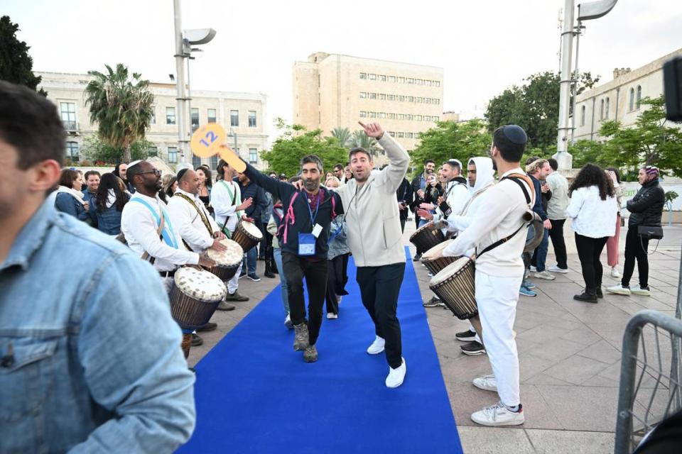 Mission participants, including Josh Kligler of Miami Beach (in the beige sweater) and one of the tour guides, were greeted by sounds of drums and shofars at the opening ceremony.