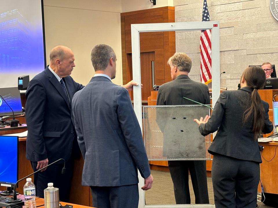 Special prosecutors Tim Merkle, Josh Shaw and Gary Shroyer stand with the storm door from the home of Casey Goodson Jr.'s grandmother during the testimony of Dr. Anne Shepler, a former Franklin County deputy coroner in the murder trial of Jason Meade.