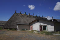 The Celilo Village longhouse is supported by tall wooden beams in Celilo Village, Ore., on Sunday, June 19, 2022. In Native families that inhabit the Columbia Basin, education about first foods begins at home and continues in the longhouse, accompanied by teaching and ceremony. (AP Photo/Jessie Wardarski)